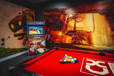 A climax branded pool table with games machines behind