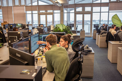 Team working together in front of computer set up